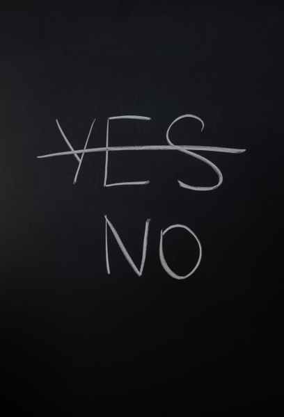 A black chalkboard with the words Yes and No written on it. The word Yes is crossed out.